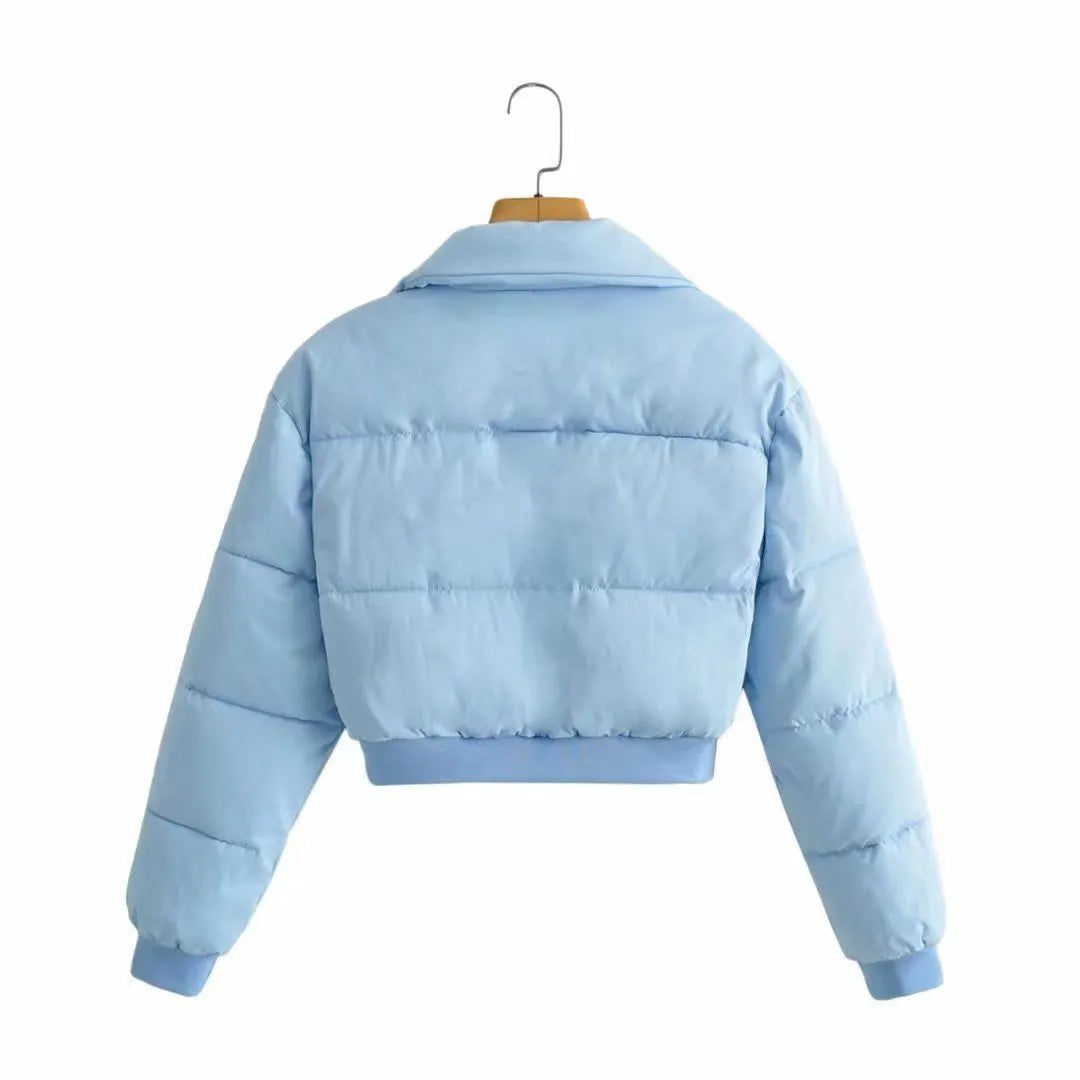 Loose fit blue women's polyester jacket with long sleeves on a hanger