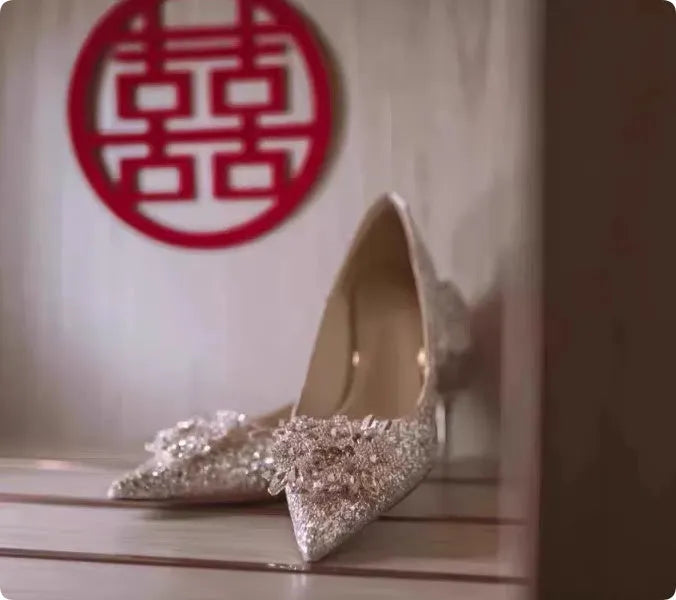 Champagne coloured women's wedding shoes with rhinestone flower pattern, pointed toe, and a fine heel.