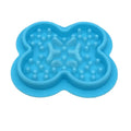 Silicone slow feeder licking pad for pets in various colours on a kitchen counter.
