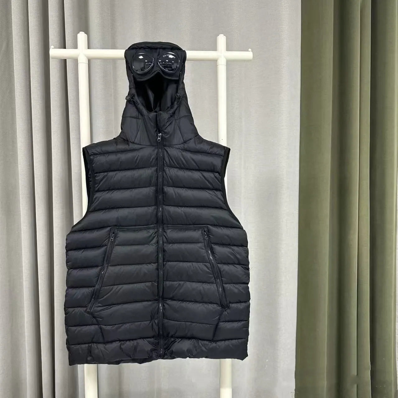 Men's loose hooded cotton vest jacket in black, side view, showing hood and zip closure
