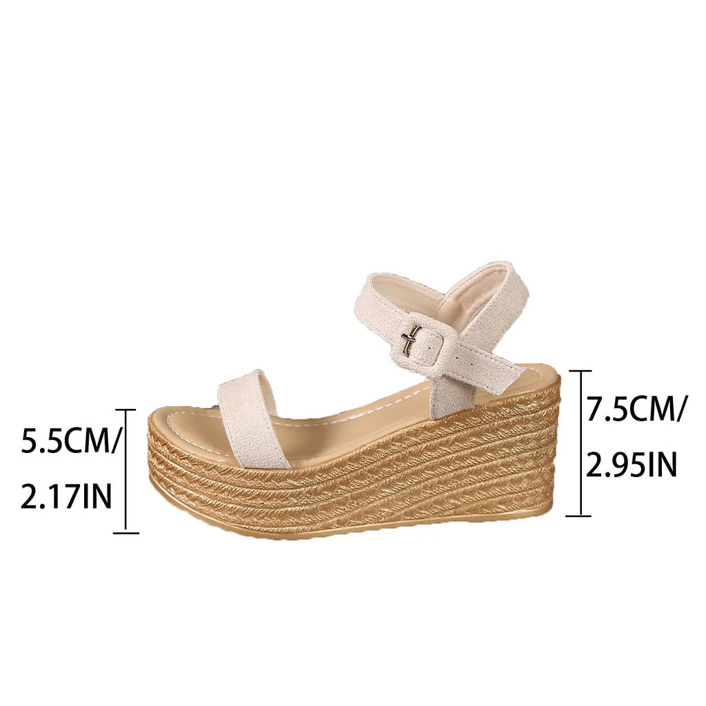 Beige women's suede platform wedge sandals with round toe and buckle closure on a light background