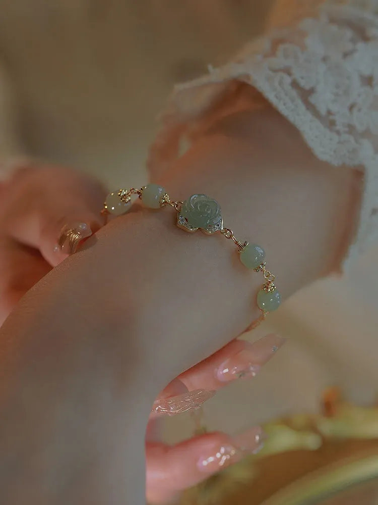Handmade women's bracelet with rose-coloured Hetian Jade and 14K gold-plated finish in a floral design.