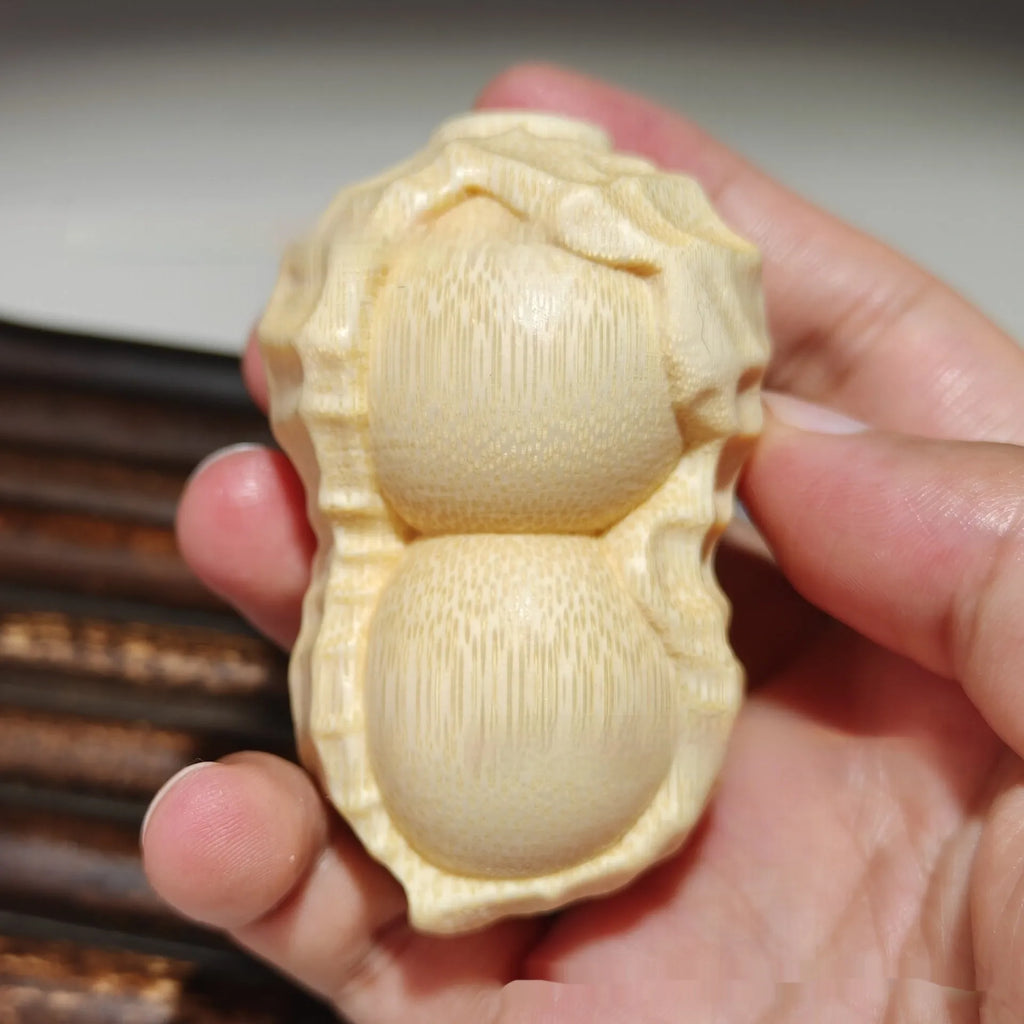 Natural solid bamboo peanut ornament with 'May Good Things Happen' engraved message.