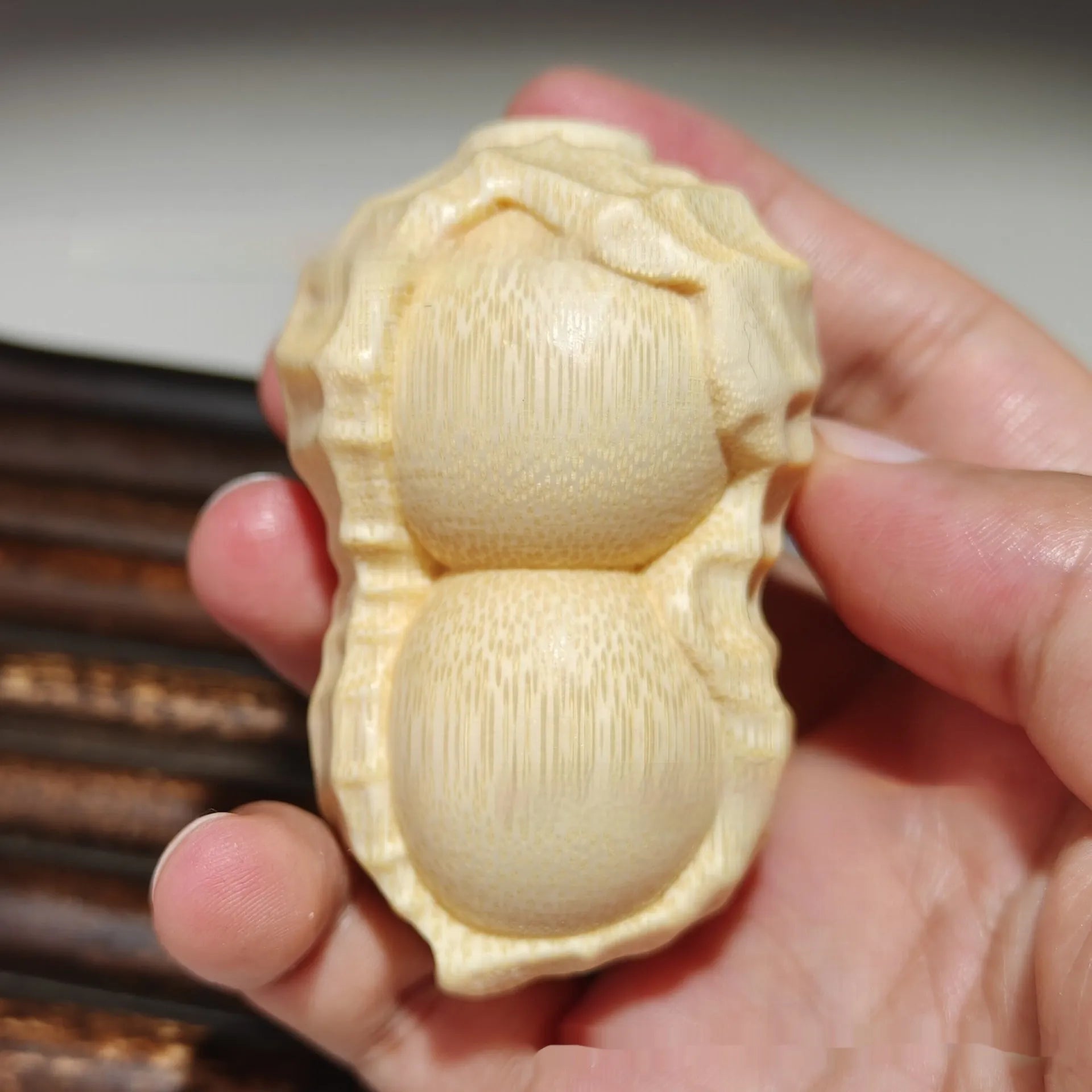 Natural solid bamboo peanut ornament with 'May Good Things Happen' engraved message.