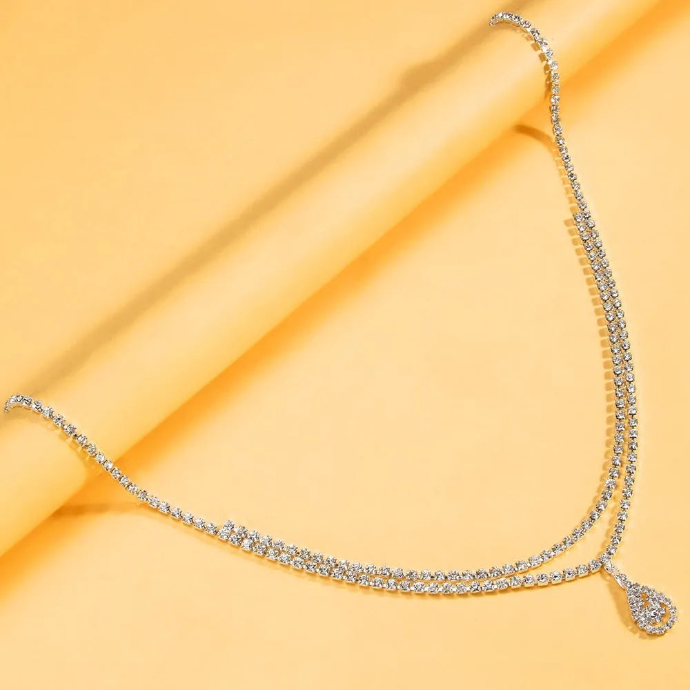 Women's rhinestone waist chain with water drop pendant showing gold and silver colour options