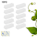 Set of sticky plastic wall-mounted brackets holding data cables on a white wall in a bedroom