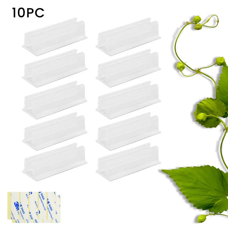 Set of sticky plastic wall-mounted brackets holding data cables on a white wall in a bedroom