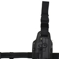 Green tactical plastic leg holster attached to a waist plate, showing quick-pull opening.