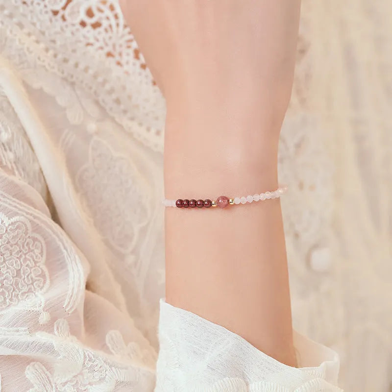 Handmade pink crystal bracelet with strawberry quartz beads and a zodiac animal charm