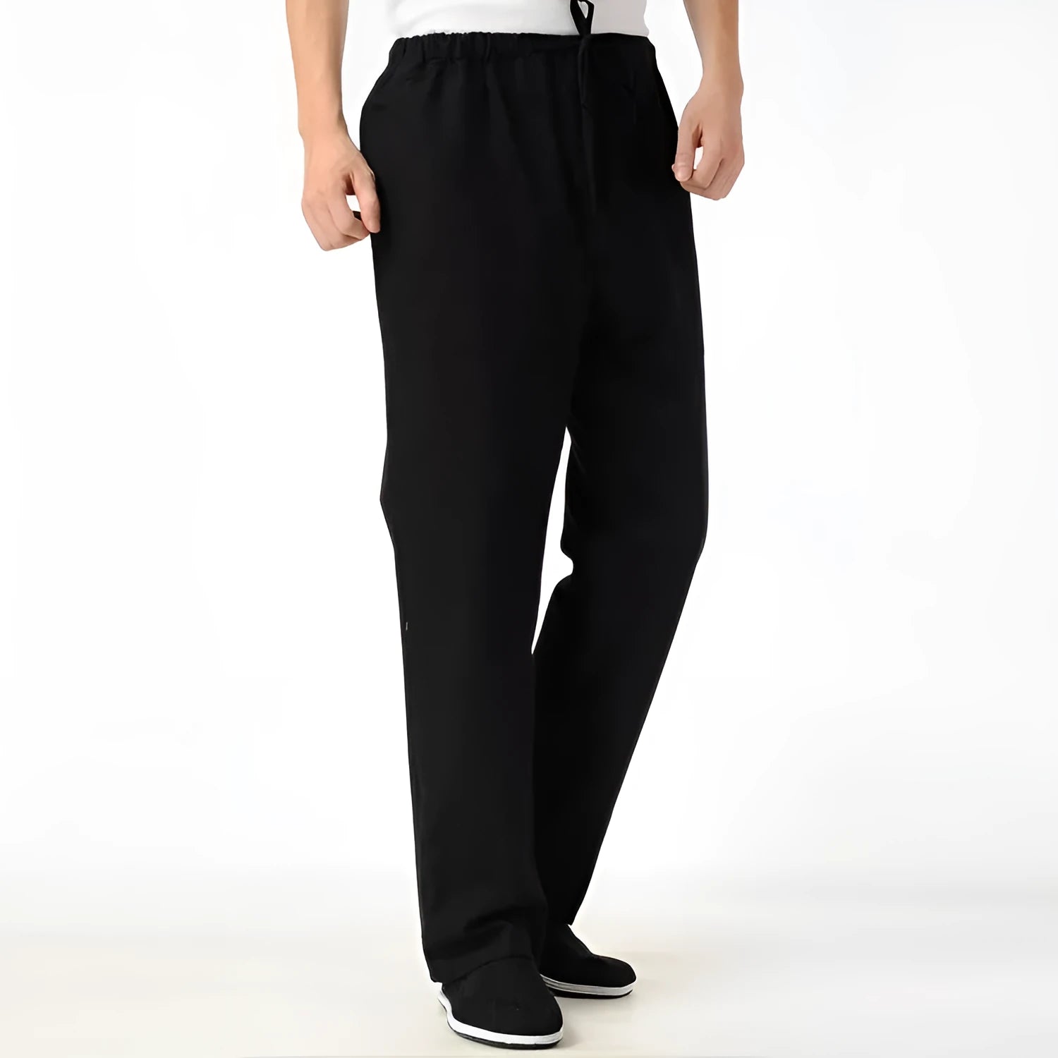 Man wearing beige pure cotton casual trousers with a drawstring waist and belt.