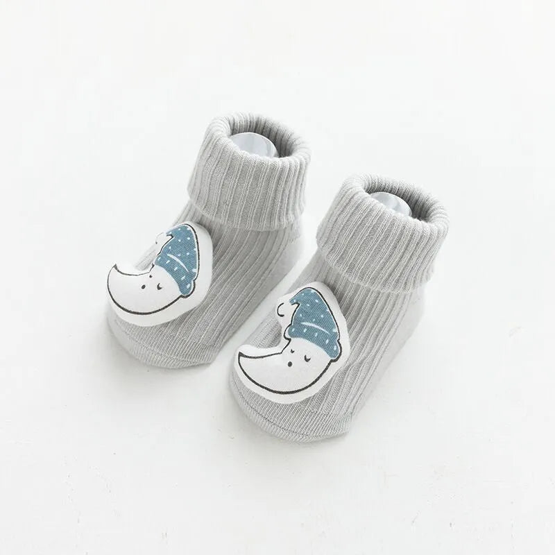 Baby socks with non-slip rubber grip soles on the feet, shown in a light grey colour.