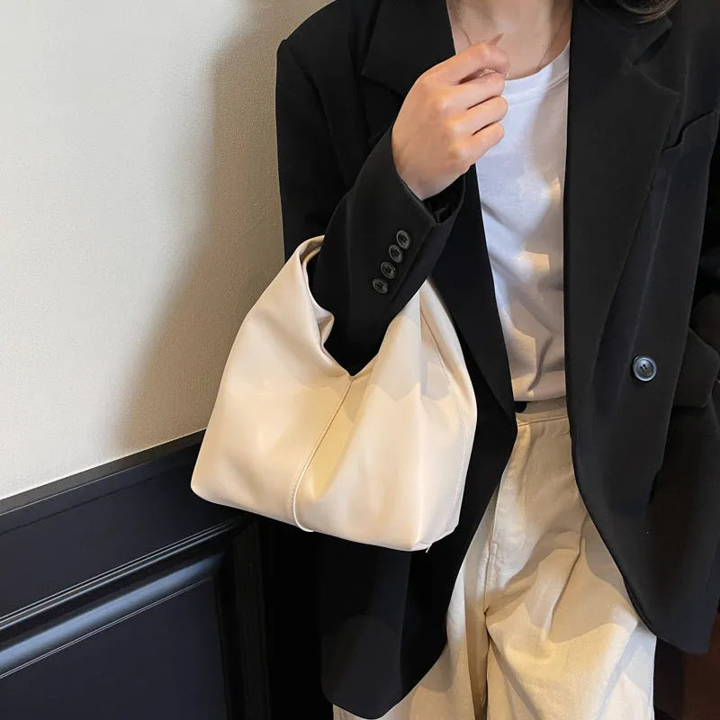 Casual dumpling-shaped women's PU shoulder bag in multiple colours showing internal phone and file pockets.