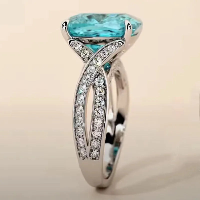 Square blue cubic zirconia women's fashion ring with adjustable metal band on white background