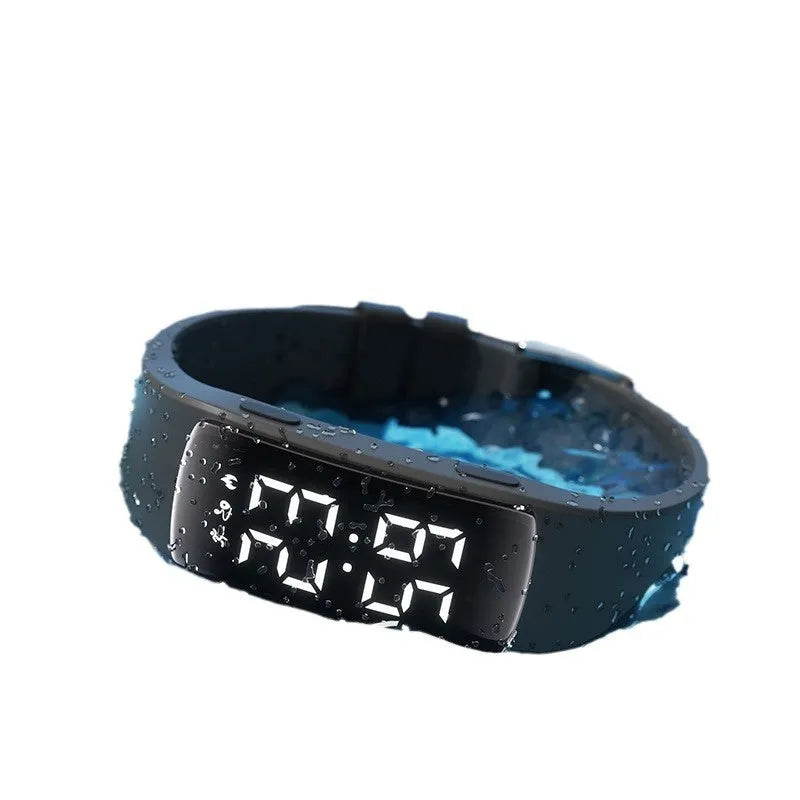 Waterproof vibration alarm watch with LED display and coloured silicone strap on a wrist.