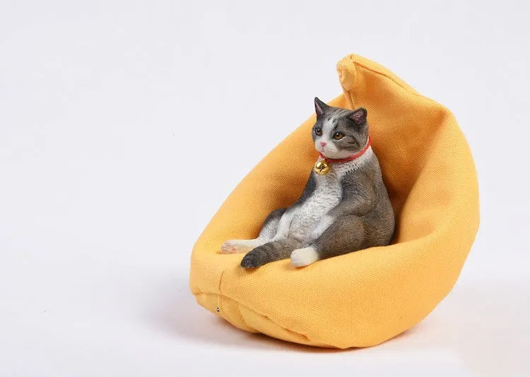 Small lazy cat model resting on a sofa, a resin car dashboard ornament decoration.