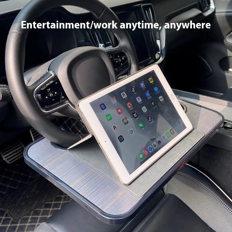 Black ABS plastic car steering wheel laptop stand with foldable design on vehicle dashboard