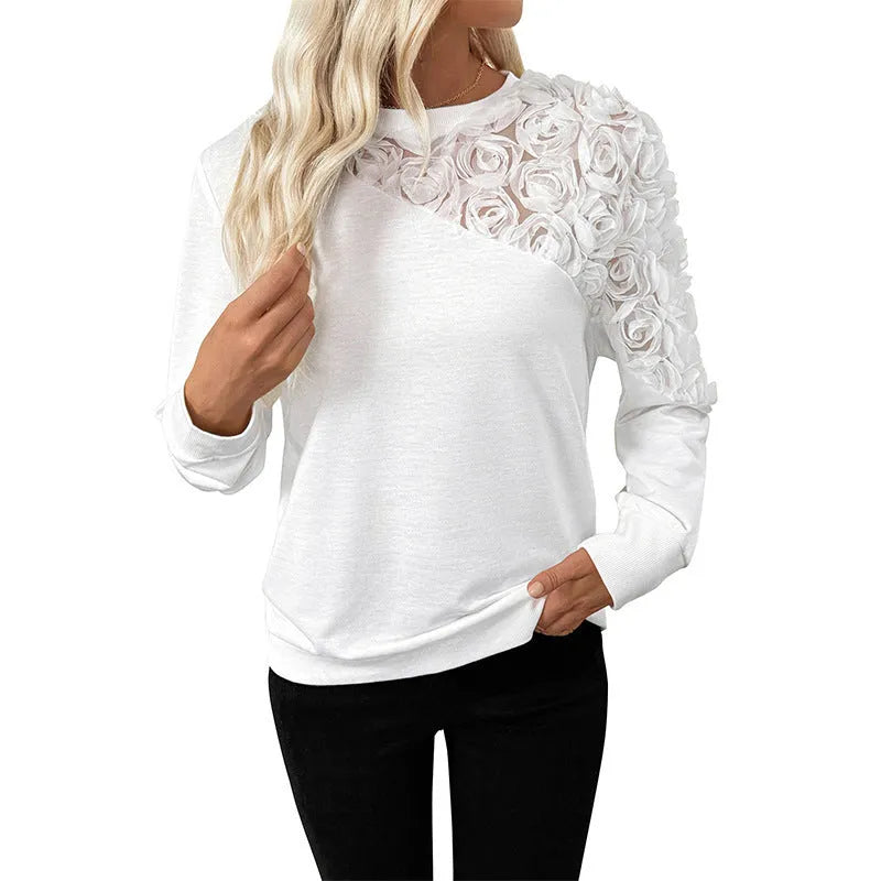 White women's long sleeve top with floral pattern, loose fit, and pullover style.