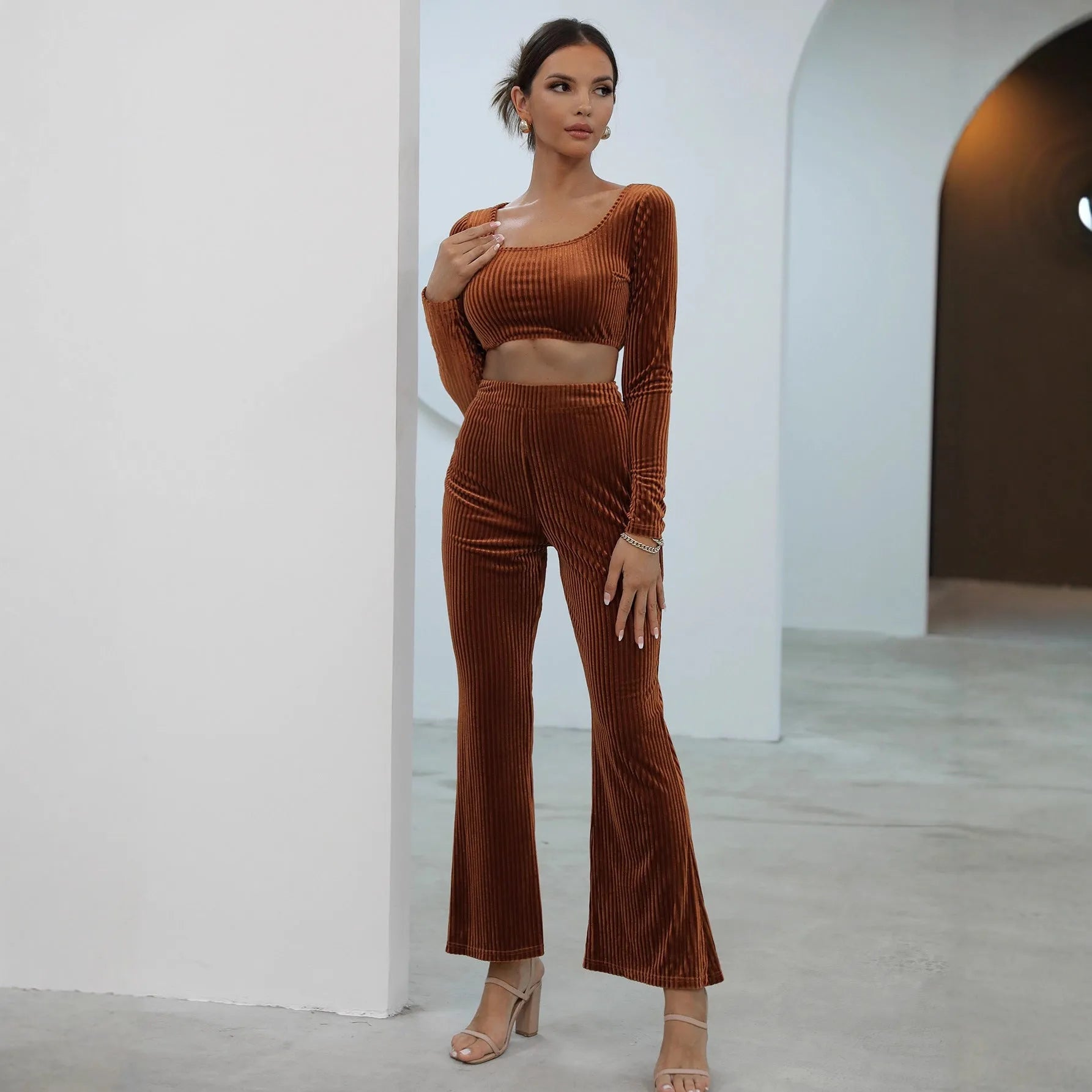 Women's caramel coloured sweater set with long sleeves and matching trousers on hanger