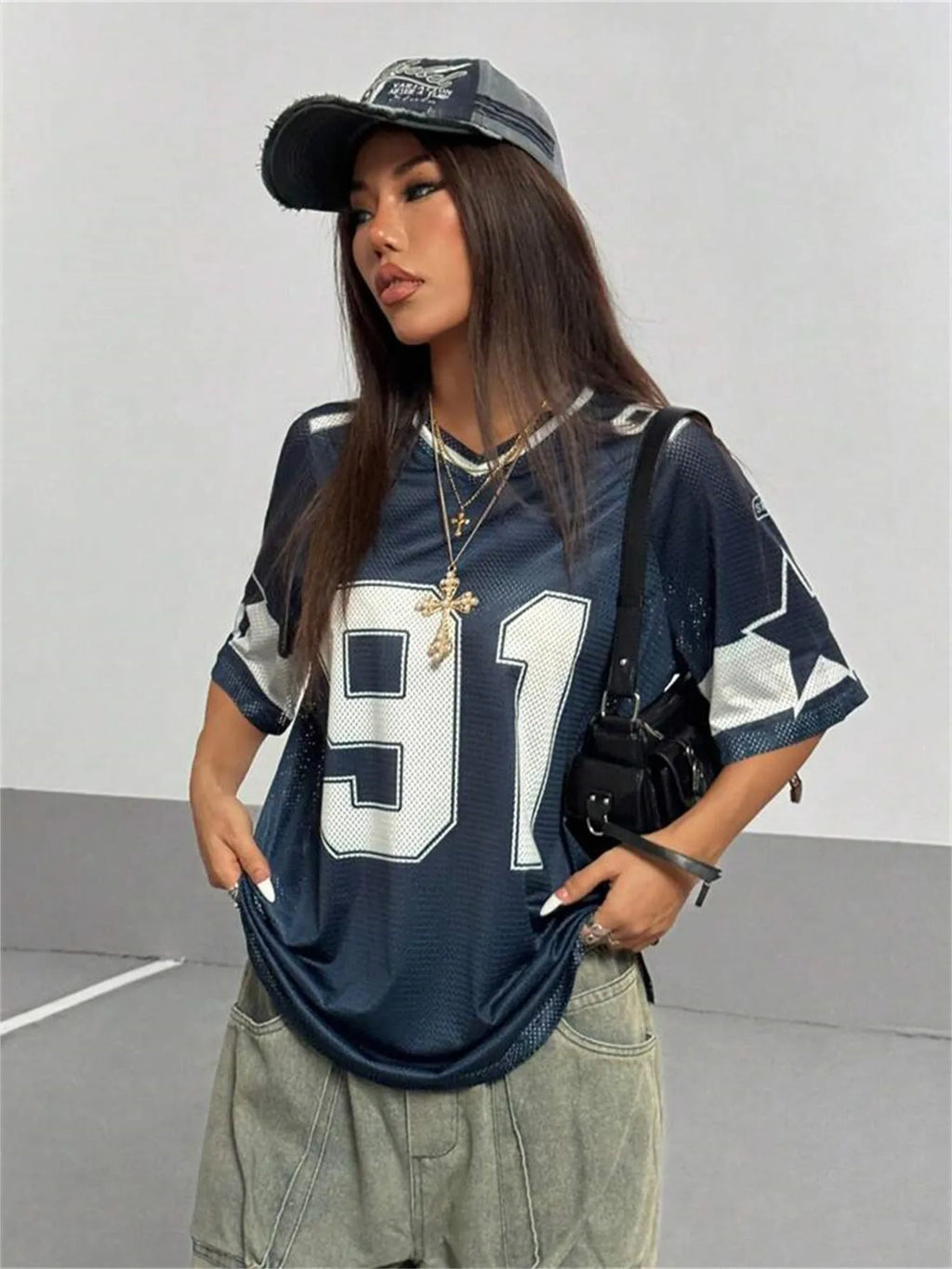 Men's loose grey V-neck t-shirt with a large white number print on the chest, short sleeves, street style.