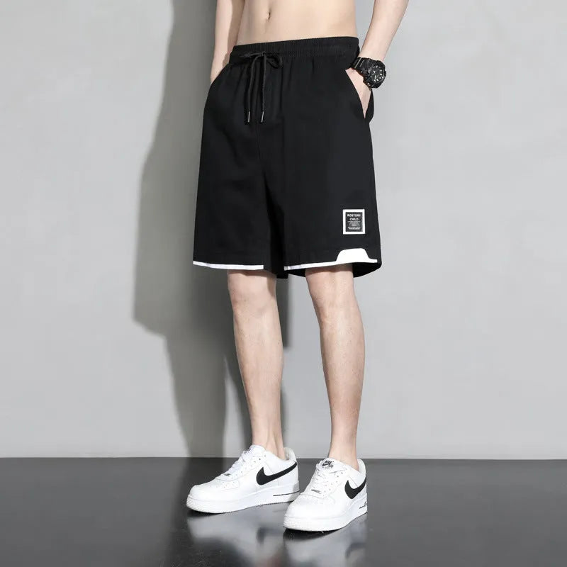 Boy wearing black cotton plus-size shorts with a mid-waist and casual overalls style.