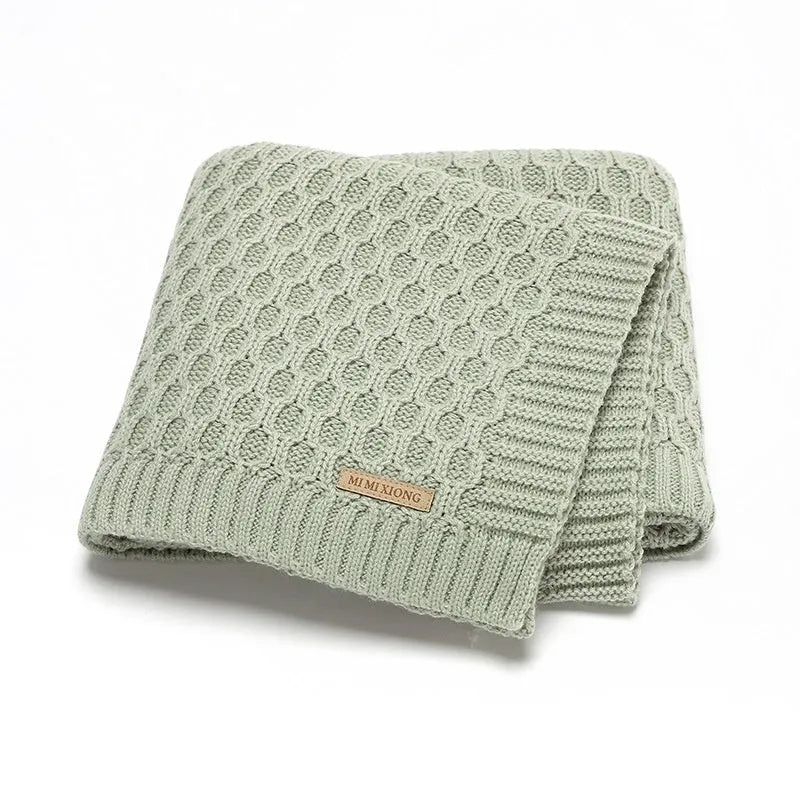 Solid colour infant blanket with raised line texture in beige khaki, laid flat showing 70x90cm size.