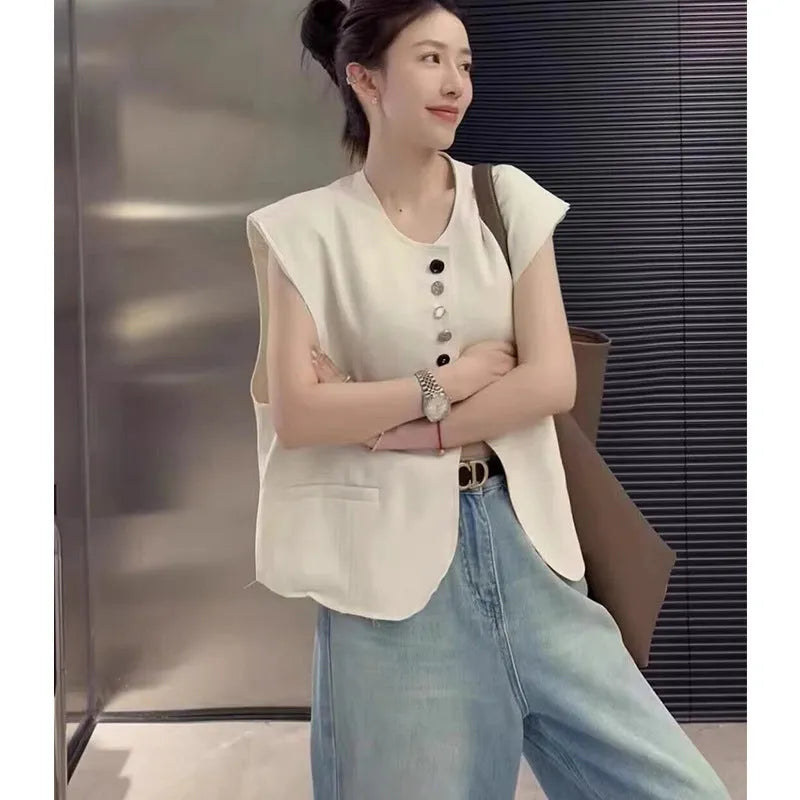 Women's loose fit polyester vest in short length with pockets, shown in milk white colour