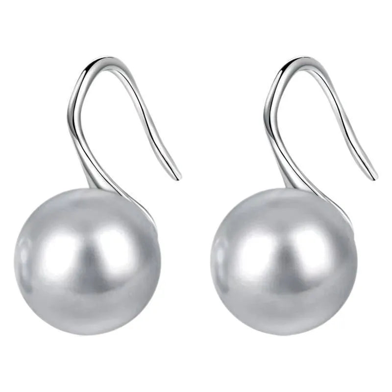Silver round stud earrings with 12mm white shell pearl inlay on simple background