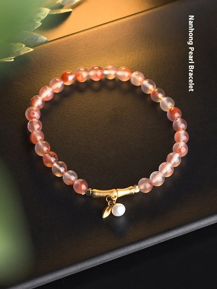Nanhong agate bracelet with flower design and bamboo joint elements on wrist