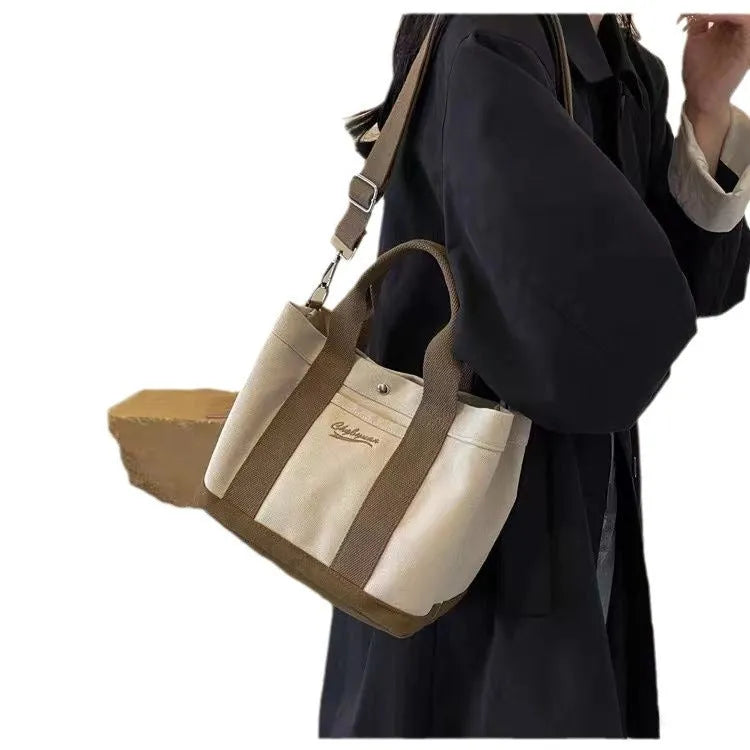Beige soft canvas bucket-shaped messenger bag with sandwich pockets and three shoulder straps