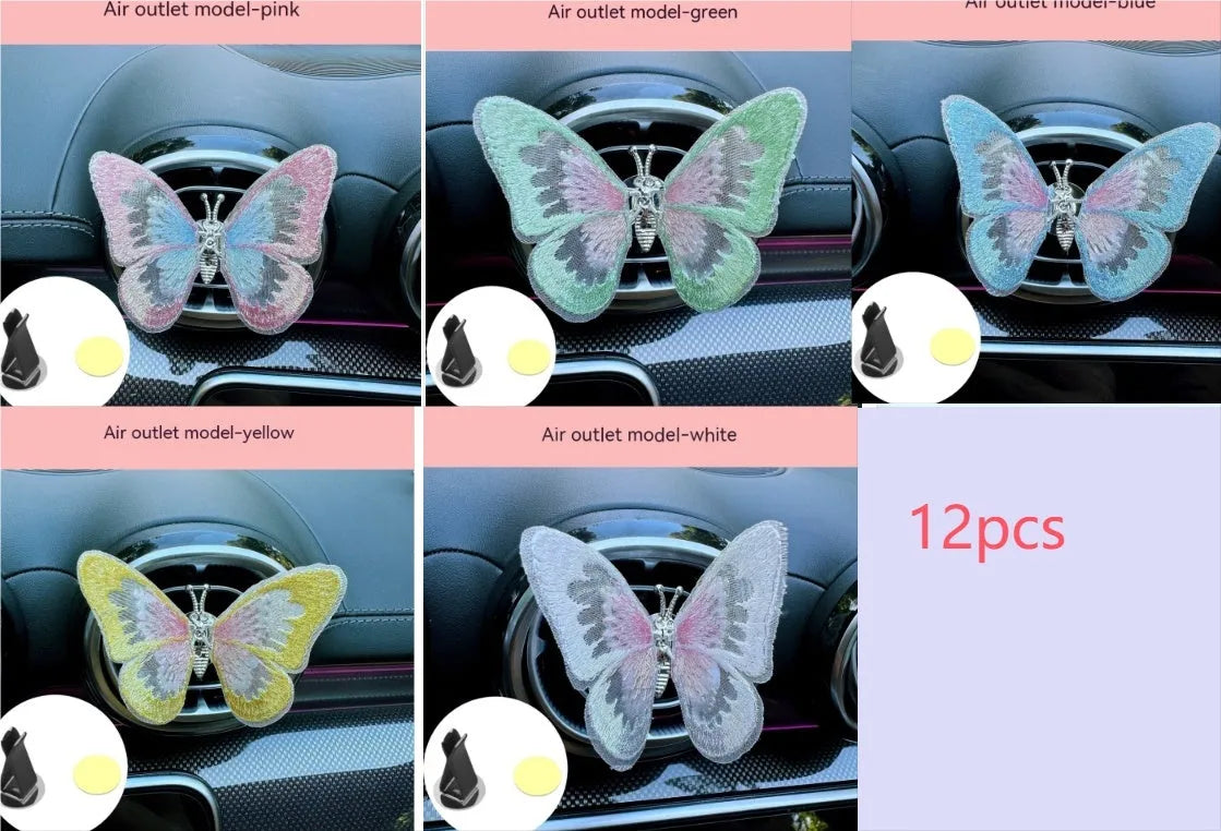 Fabric embroidered butterfly car air vent decoration in multiple colour options on a dashboard.