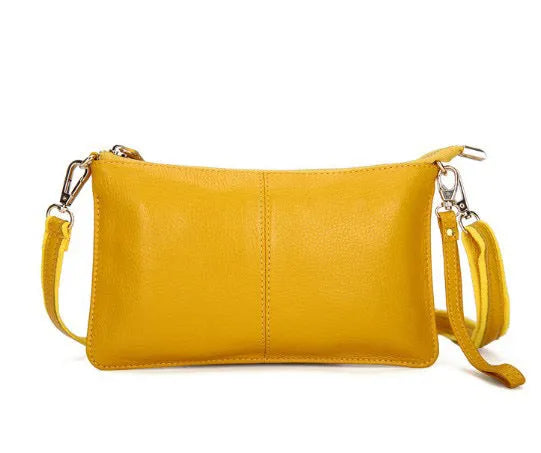 Lady's cowhide leather slant bag in apricot colour with hand strap and shoulder strap showing zipper compartments