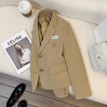 Women's black loose-fit short suit coat with pockets, shown on a hanger.