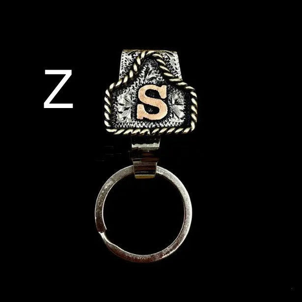 Handmade metal cow tag style key holder shown in one of its 26 colour options, attached to a keyring.