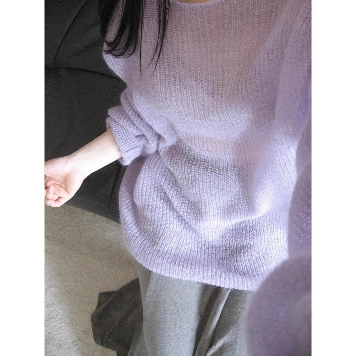 Purple women's blouse with hollow out design and princess sleeves on a hanger.