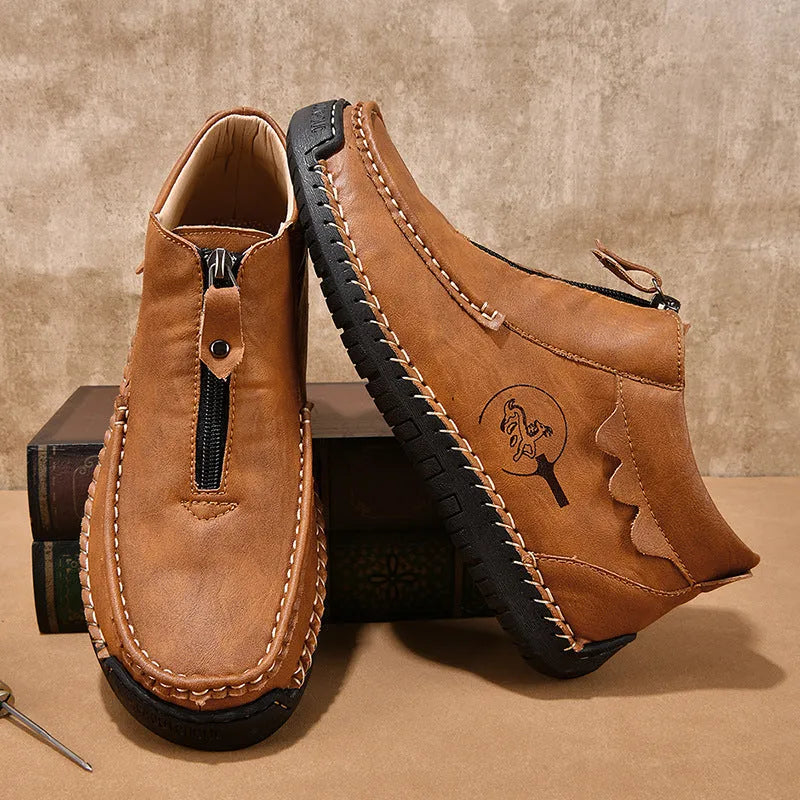 Men's black slip-on loafers with round toe and visible stitching on a rubber sole.