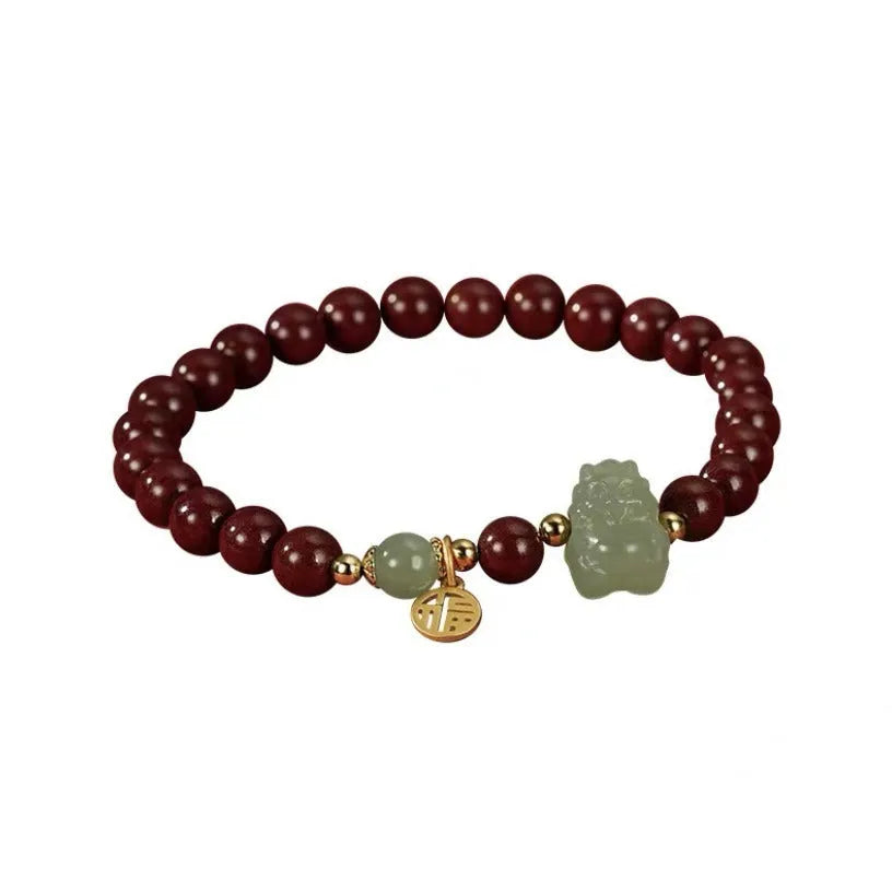 Handmade Hetian jade bracelet with cinnabar inlay showing 8mm beads and animal zodiac modelling