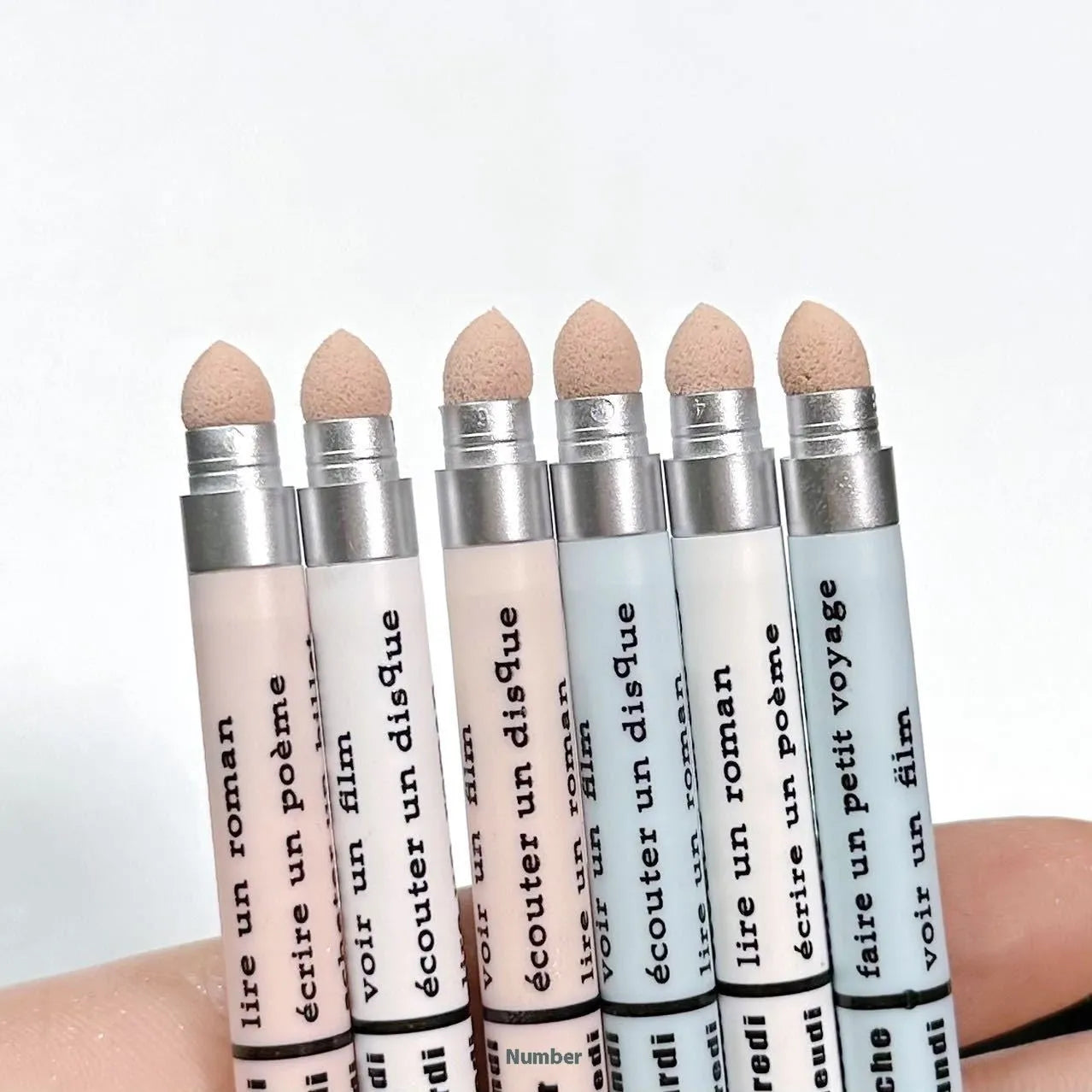 INS style 2-in-1 waterproof eye shadow pen in a selection of 14 brightening colours on a white background.