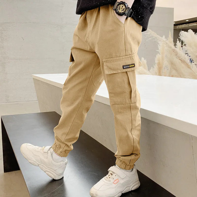 Boys' casual cotton summer trousers in army green, shown flat with size label visible.