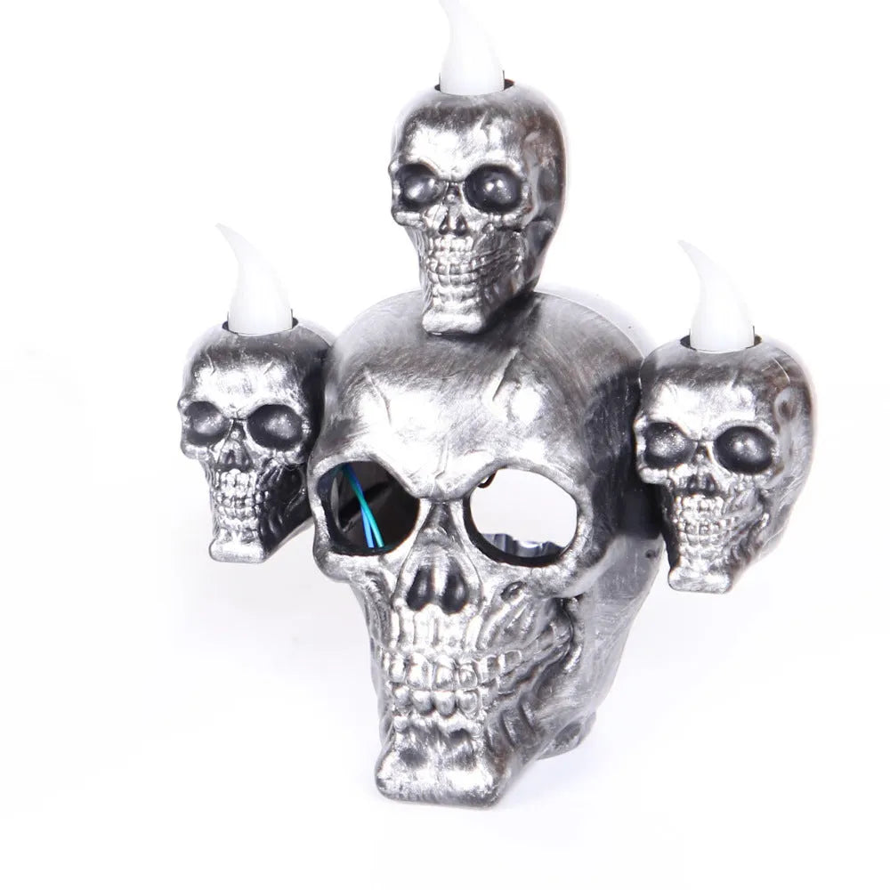 Halloween skull ornament with LED light, gold and silver, plastic, 14x12x9cm, on dark background