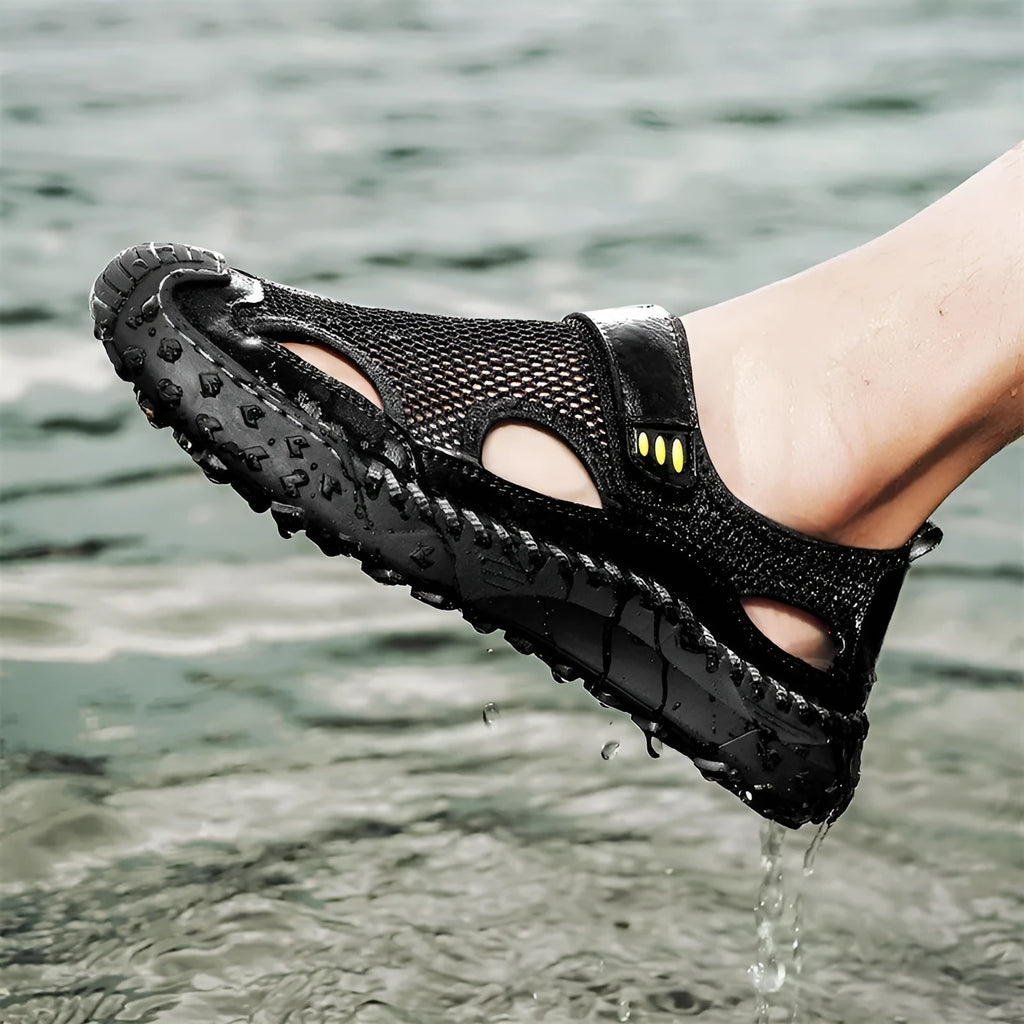 Men's black casual sandals with mesh upper and velcro straps on a rubber sole.