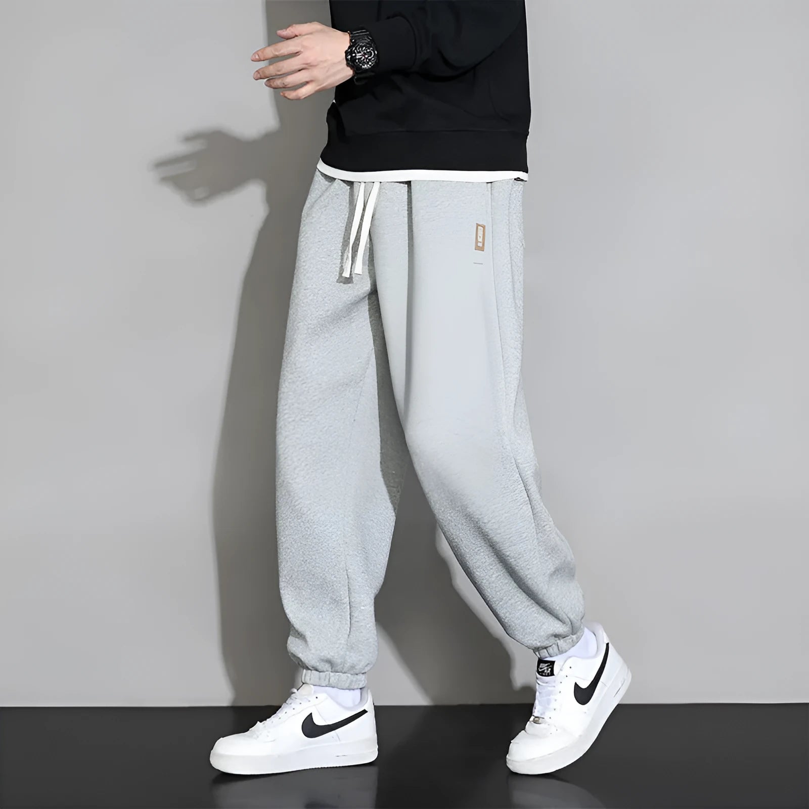 Men's loose fit sports trousers in grey colour with elastic waistband and drawstring closure