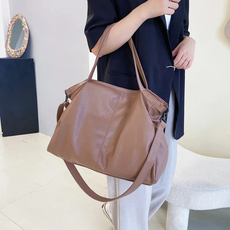 Soft surface messenger shoulder bag in horizontal square shape with zipper opening and internal compartments