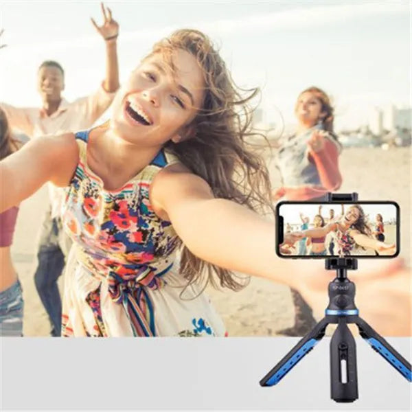 Black plastic and aluminium desktop tripod holding a mobile phone for video calls.
