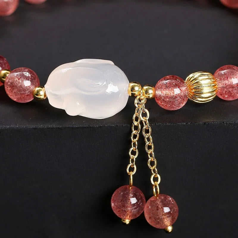 Handmade women's bracelet with natural strawberry quartz and agate 6mm round beads on a wrist.