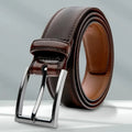 Men's brown genuine leather casual belt with a silver alloy buckle on a plain background.