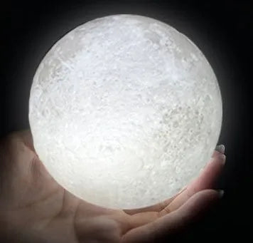 3D printed white moon lamp on wooden stand with touch-sensitive metal ring at base.