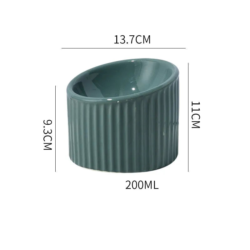 Ceramic elevated cat bowl in green colour with tilted round design for comfortable feeding.