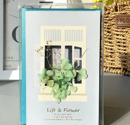 Handmade 3D butterfly-shaped greeting card with artificial flowers in a box, alongside its matching envelope.