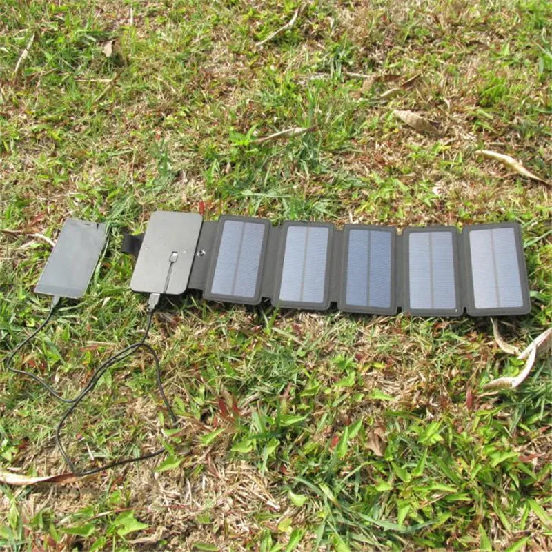 Folding solar panel charger with monocrystalline silicon cells, USB output, and compass buckle in black