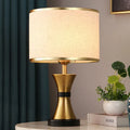 Black, gold, or white bedside table lamp with a fabric shade and iron base